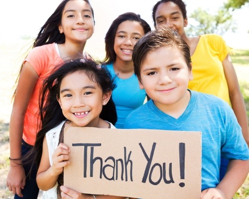 Kids holding thank you sign