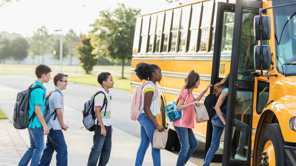 kids getting onto school bus